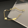 2-503.png Yves Saint Laurent Cassandre Logo And Heart Charm Bracelet Gold-Tone