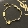 3-490.png Yves Saint Laurent Cassandre Logo And Heart Charm Bracelet Gold-Tone