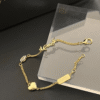 6-288.png Yves Saint Laurent Cassandre Logo And Heart Charm Bracelet Gold-Tone