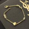 7-160.png Yves Saint Laurent Cassandre Logo And Heart Charm Bracelet Gold-Tone