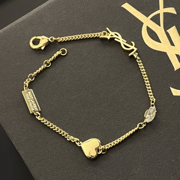 7-160.png Yves Saint Laurent Cassandre Logo And Heart Charm Bracelet Gold-Tone