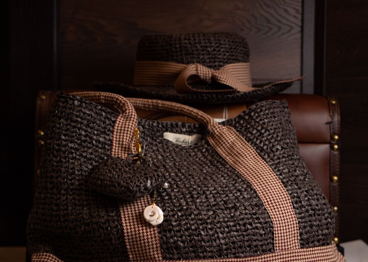 Stylish brown woven bag with matching hat, perfect for fashion-forward accessories.